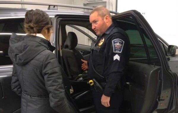 officer inspecting car seat