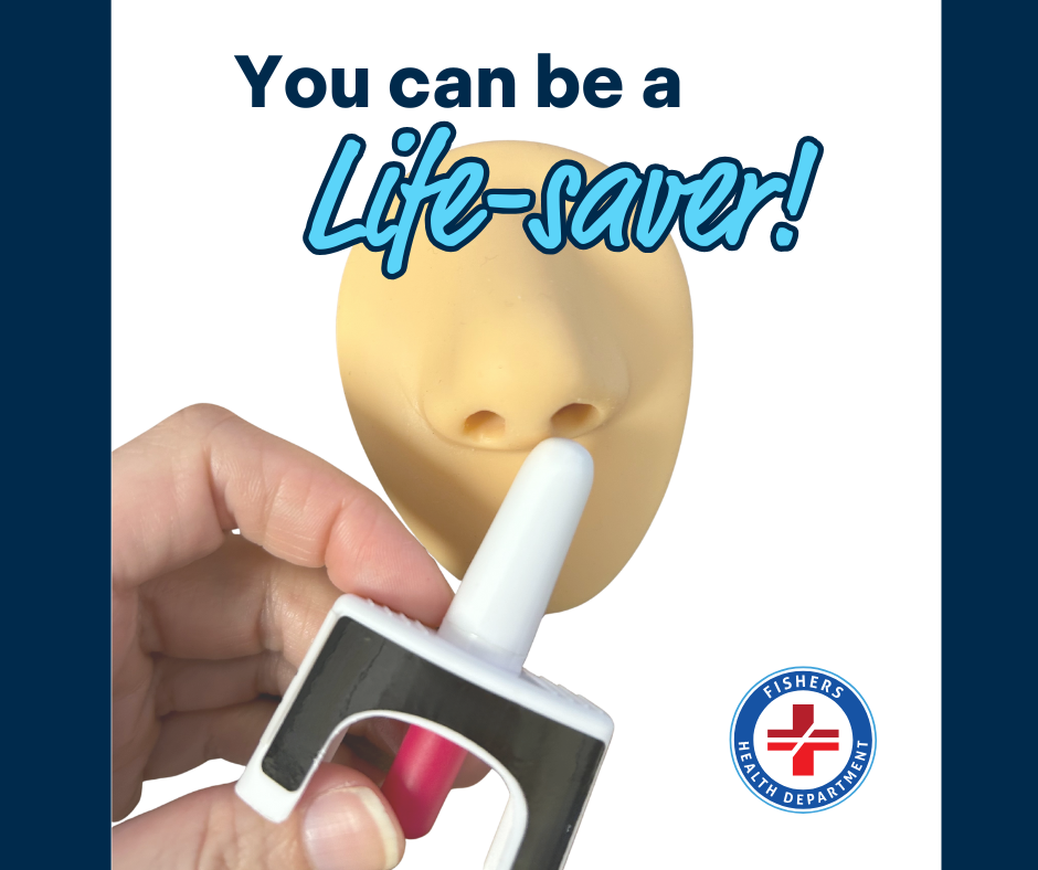 hand holding practice naloxone spray pointed towards fake nose.